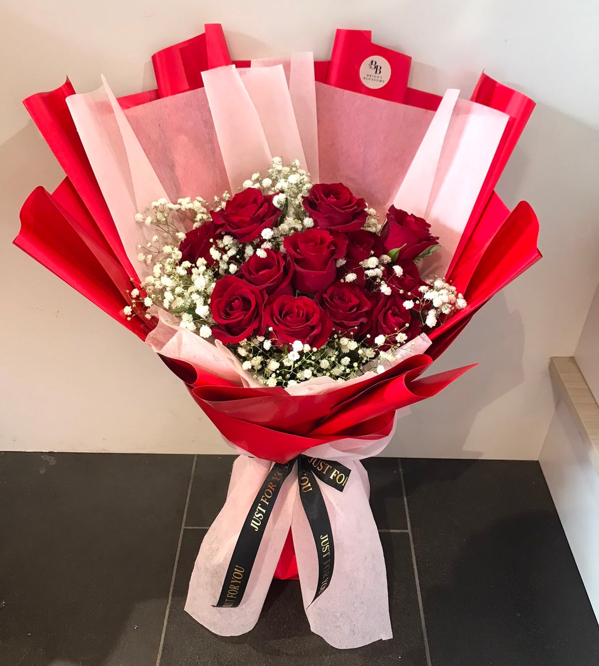 12 premium red roses paired with fresh baby’s breath, wrapped in elegant premium paper.