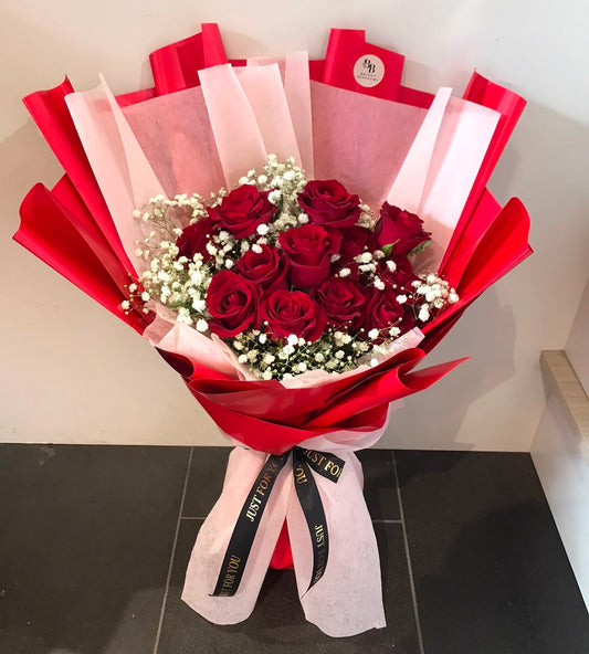12 premium red roses paired with fresh baby’s breath, wrapped in elegant premium paper.
