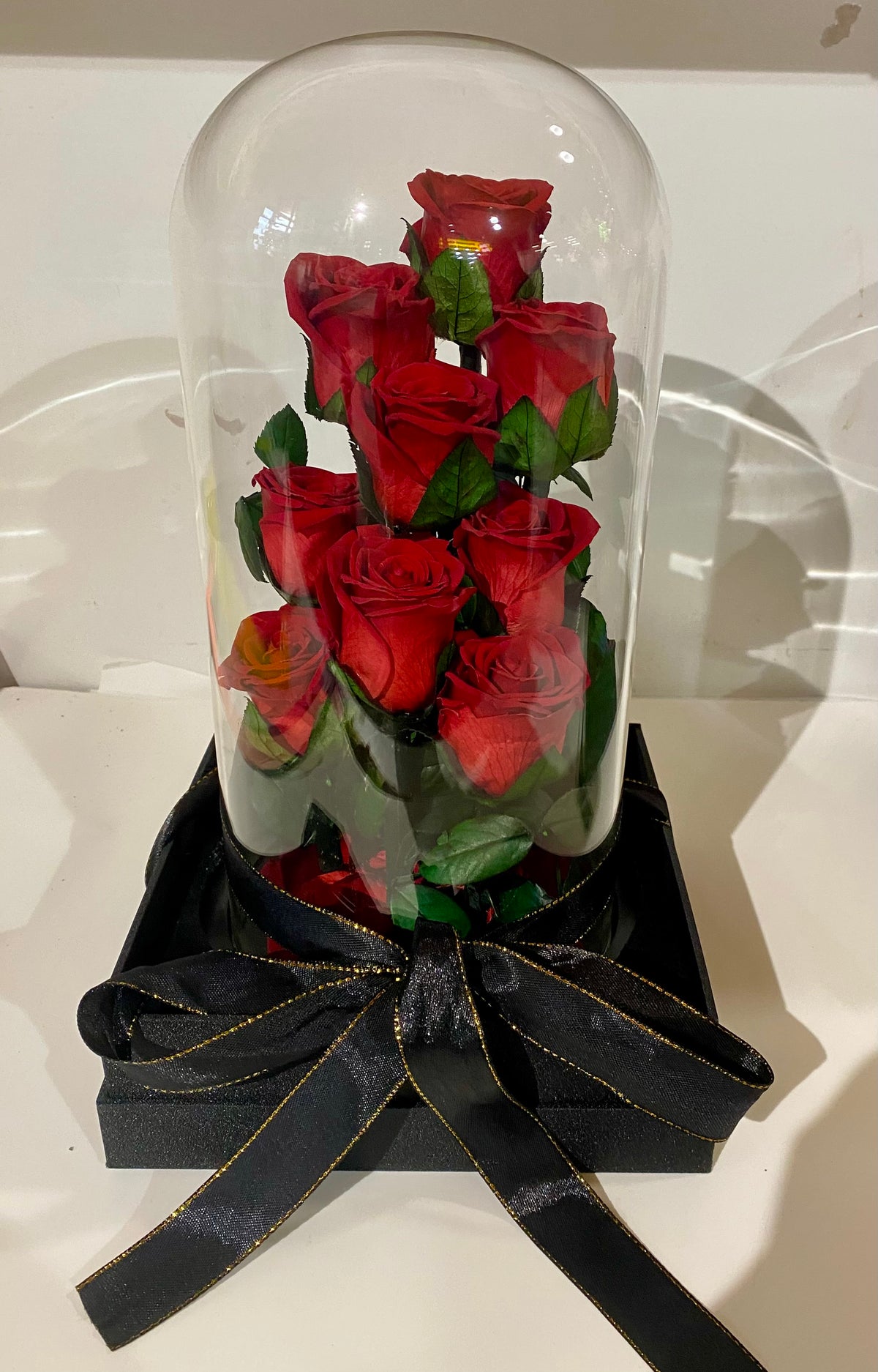 Everlasting Rose Dome with nine preserved red roses displayed under a clear glass dome on a premium base.