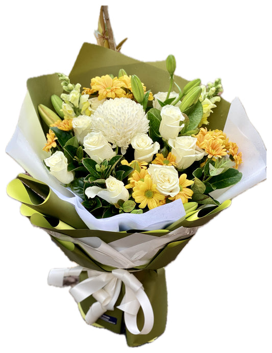 Golden Glow Bouquet featuring bright yellow blooms and soft complementary flowers arranged in a cheerful, sunlit floral bouquet.