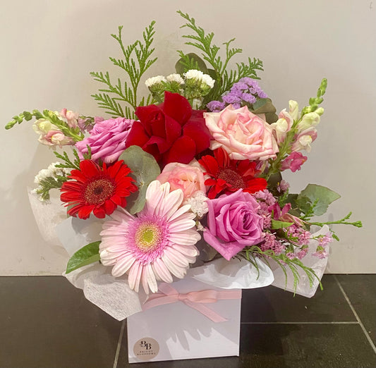 Bright Bloom Box featuring a colourful mix of roses, gerberas and seasonal flowers arranged in a petite white gift box with soft ribbon