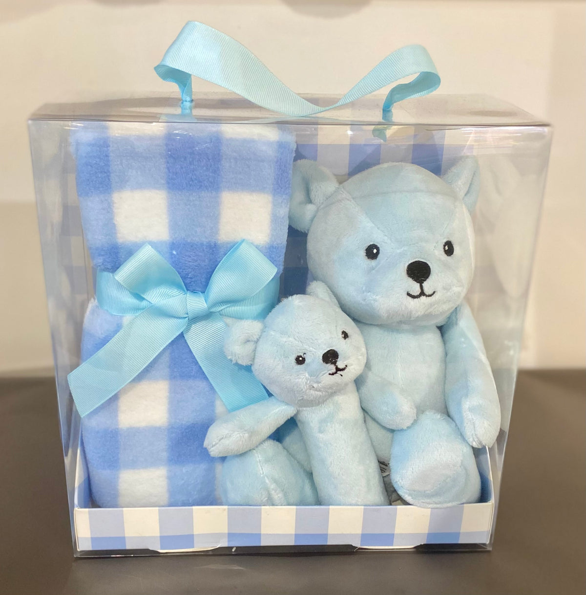 Blue baby gift pack featuring a soft blue teddy, cosy fleece blanket and matching baby rattle, presented as a sweet newborn gift set
