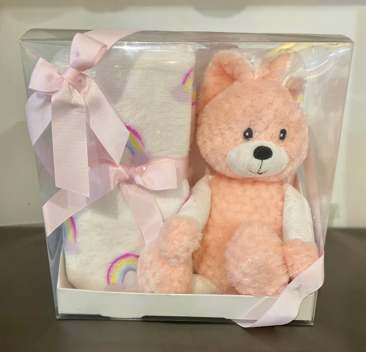 Peach bunny soft toy with matching peach baby blanket, presented as a cosy newborn gift pack