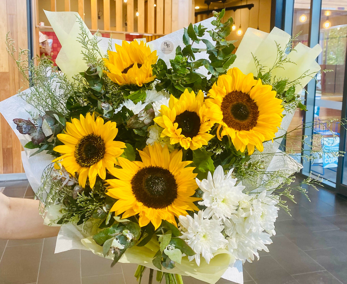 Sunflower Bouquet featuring fresh bright sunflowers arranged with soft seasonal foliage for a vibrant, uplifting display.