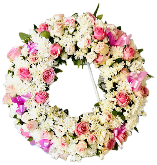 Pink Serenity Wreath, 65cm, featuring soft pink and white blooms with delicate greenery arranged in a classic sympathy wreath.