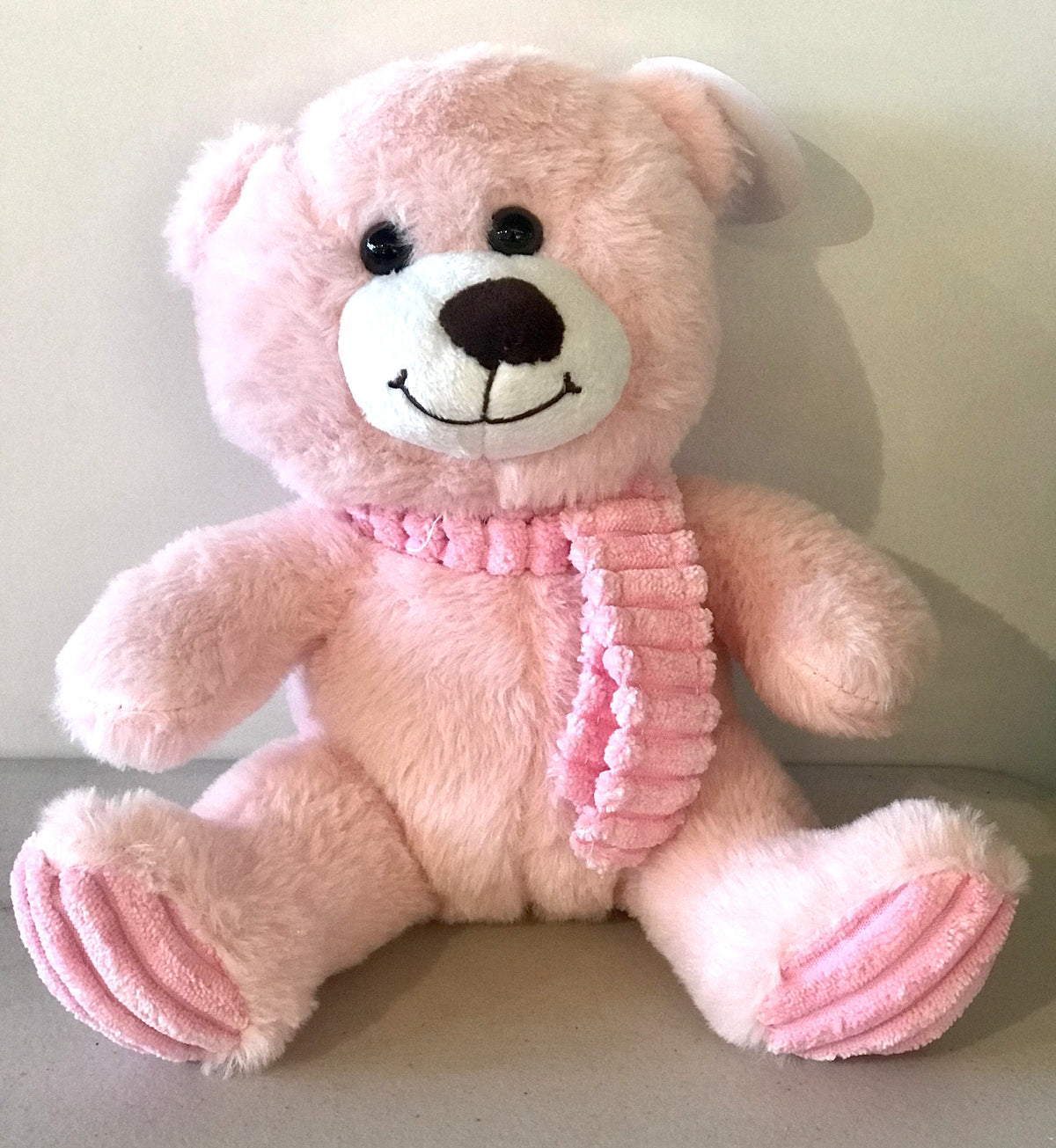 Pink plush teddy bear with a cosy scarf, 24cm tall, presented as a cute keepsake gift