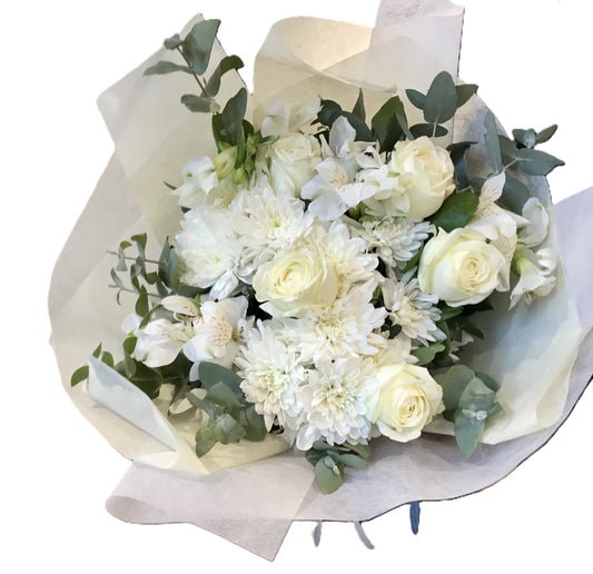 Pure Serenity Bouquet featuring white roses, chrysanthemum, alstroemeria arranged with soft seasonal foliage.